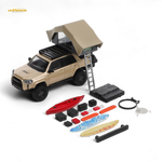 Model toy truck with rooftop tent and accessories on a white background
