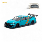 Turquoise model car with orange stripes on a white background