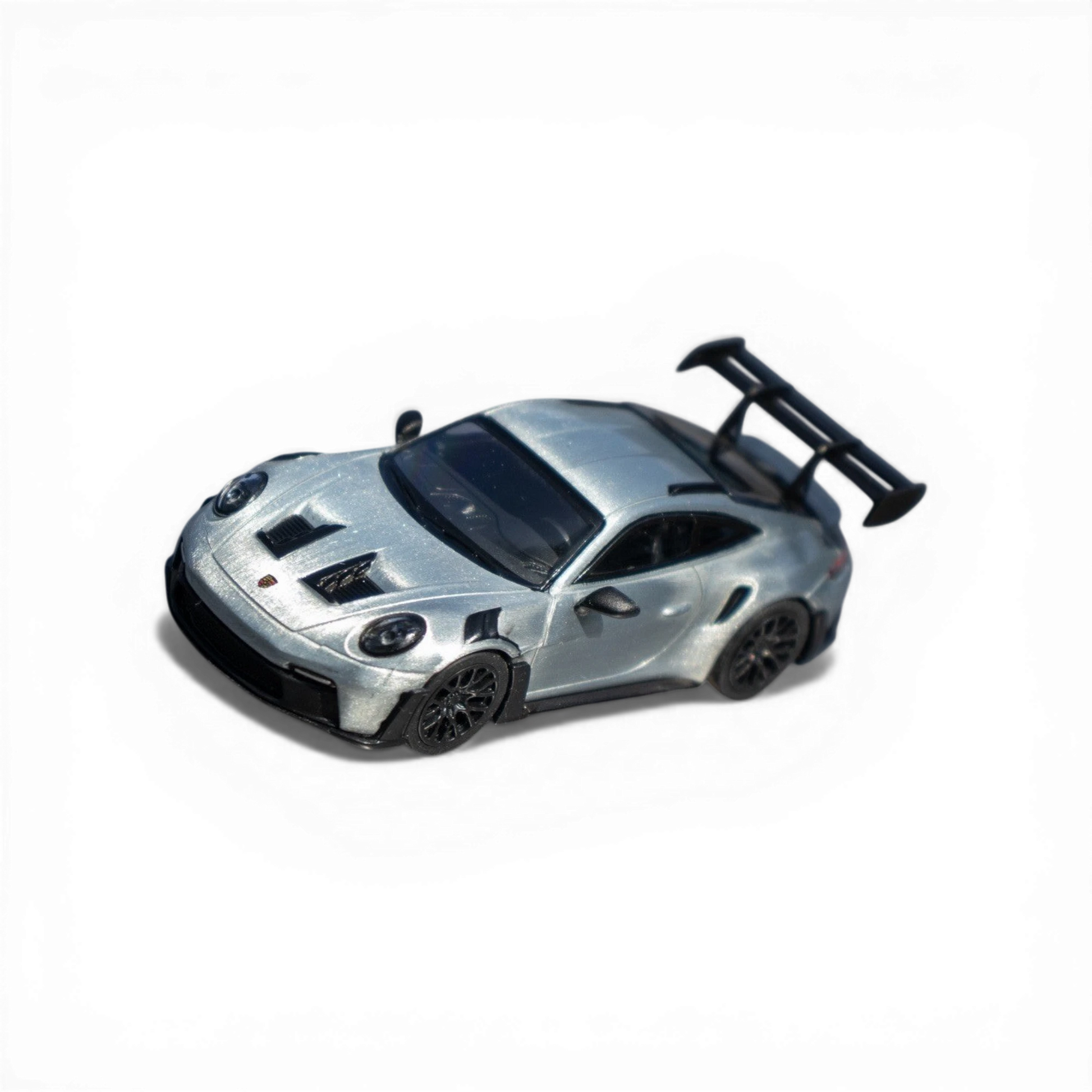 Lot57Supplies Diecast Shop Minichamps Porsche 911 GT3 RS 1:64 scale raw silver diecast model with large rear spoiler.