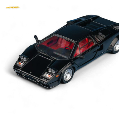 Black model car with red interior on a white background
