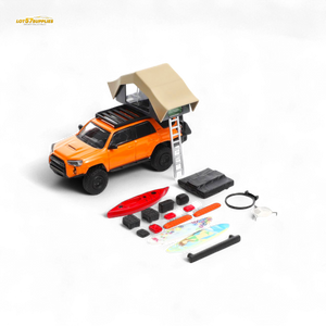 Model toy truck with rooftop tent and accessories on a white background
