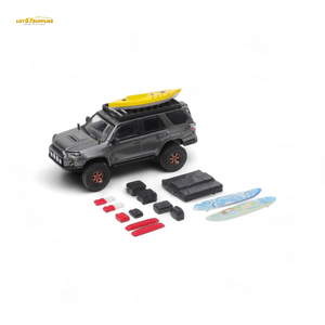 Toy SUV with a surfboard on top and accessories on a white background