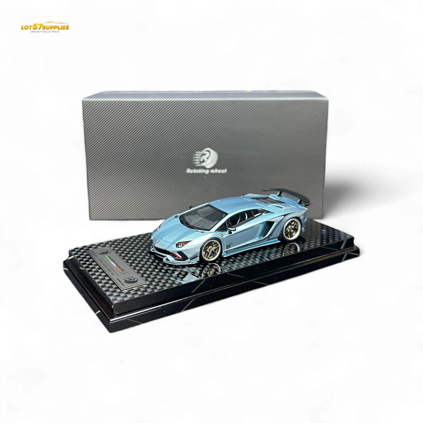 Blue model car on a black stand with a gray box in the background