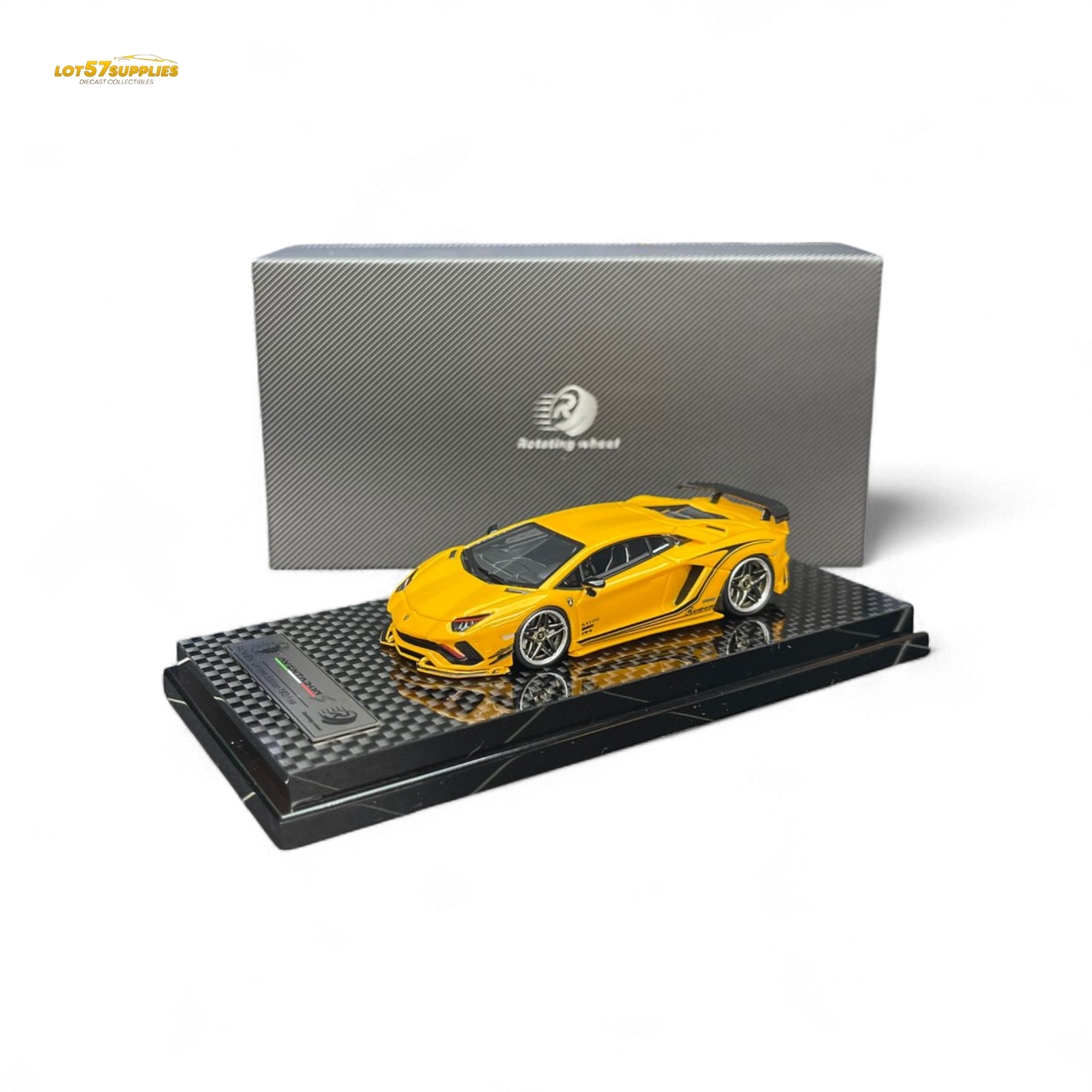 Yellow model car on a black display stand with a gray box in the background