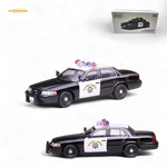 Model police car with 'SHERIFF'S DEPARTMENT' sign on a white background