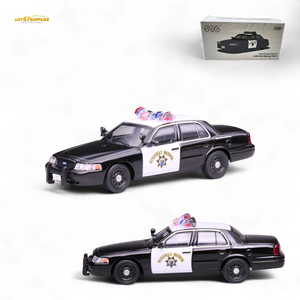 Model police car with 'SHERIFF'S DEPARTMENT' sign on a white background