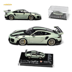 Green Porsche model car with open doors on a white background