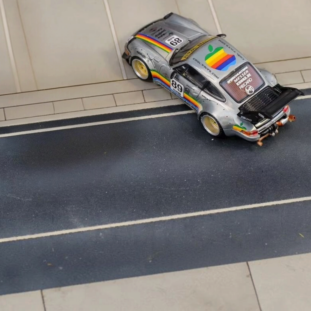 SW RWB Porsche 964 High Wing Apple Racing Livery 1:64 diecast model, high-angle rear three-quarter on road base