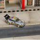 SW RWB Porsche 964 High Wing Apple Racing Livery 1:64 diecast model, front three-quarter view on a street diorama