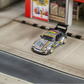 SW RWB Porsche 964 High Wing - Apple Racing Livery 1:64 diecast model, front three-quarter in a street diorama