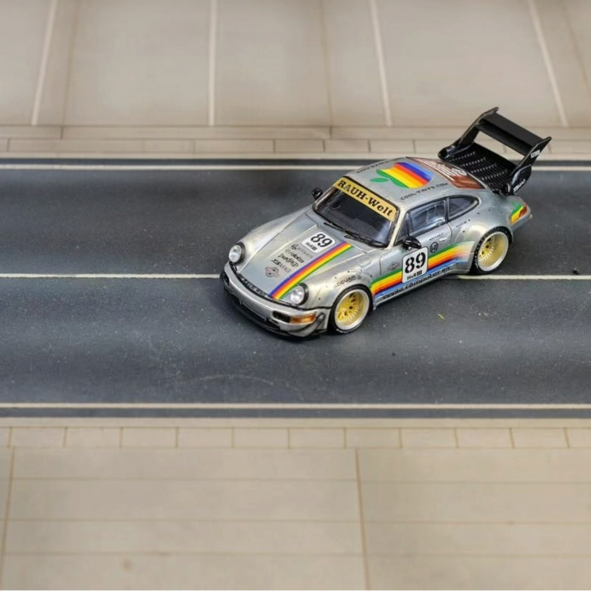SW RWB Porsche 964 High Wing Apple Racing Livery 1:64 diecast model, front three-quarter view on a road diorama