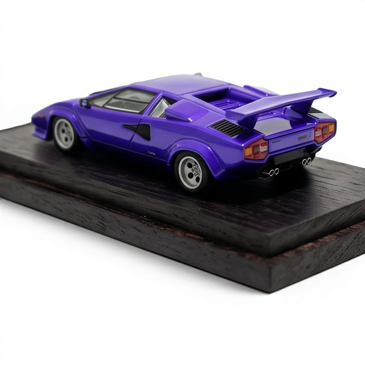 DeepMaker Lamborghini Countach 5000S 1:64 in Viola Salchi purple, on a dark wood base, rear three-quarter with quad exhausts and rear wing.