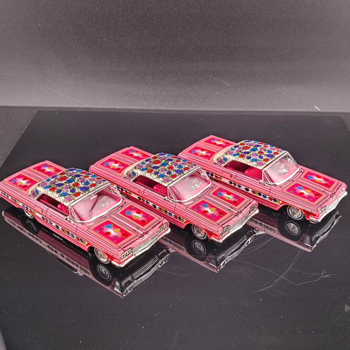 Three pink Gypsy Rose Impala hardtops lined up showing the jeweled roof graphics