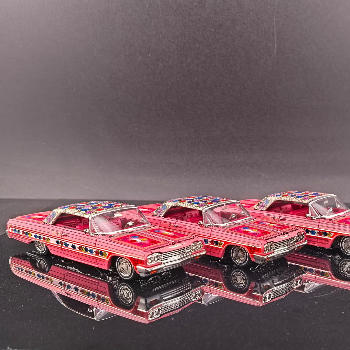 Side view of three Gypsy Rose Impala hardtops in a row on a mirror base
