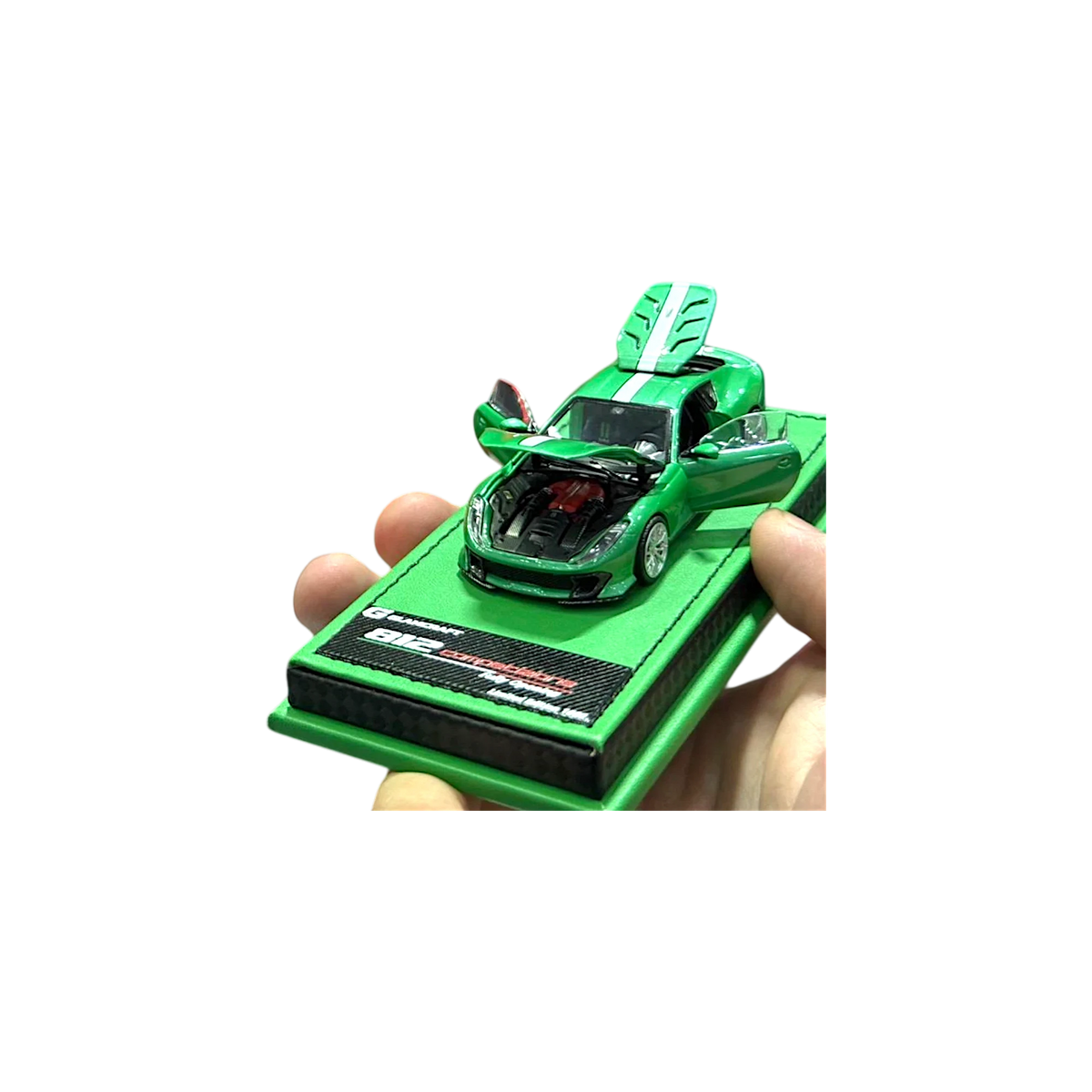 GLAMCRAFT 812C full-open diecast 1:64 in metallic green, hand-held front three-quarter with bonnet up over the engine and both doors and rear hatch open