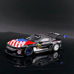GT model Ford Mustang GT3 Black Monster 1:64 diecast, front three-quarter view with flag-print bonnet and rear wing