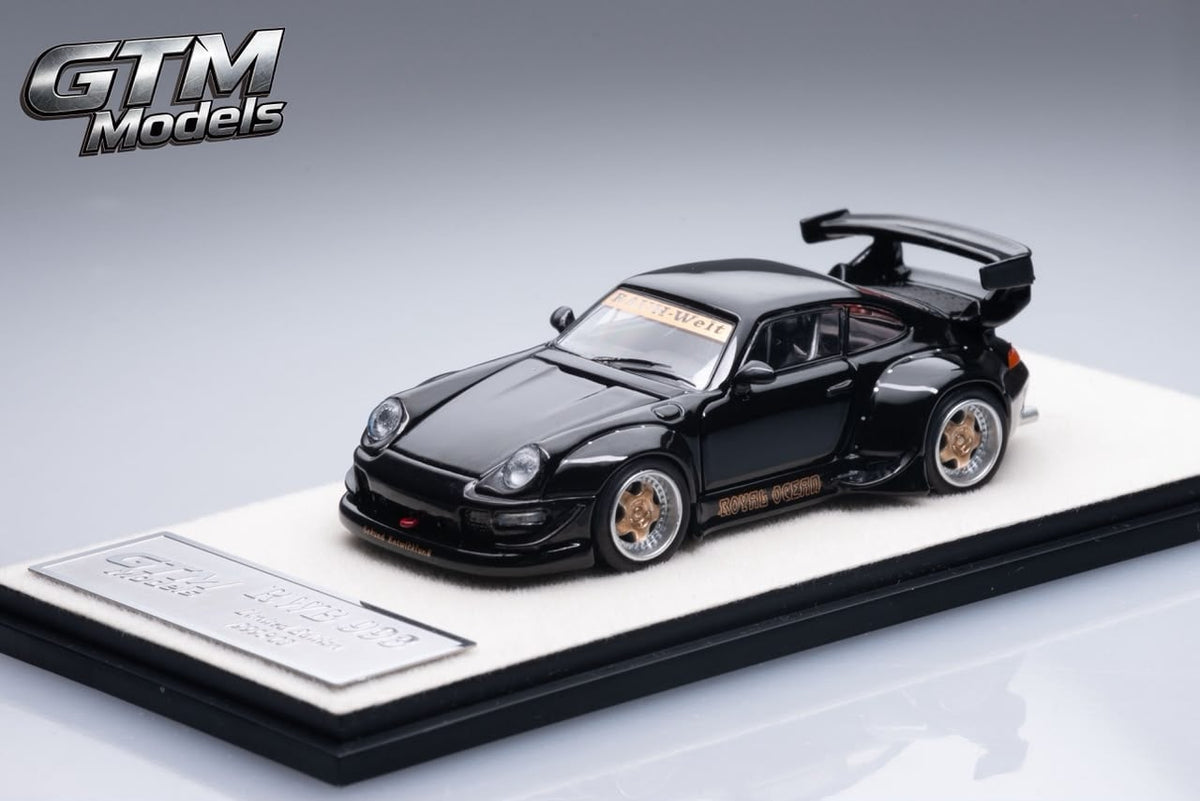 Front three-quarter view of the black GTM RWB 993 widebody on its base
