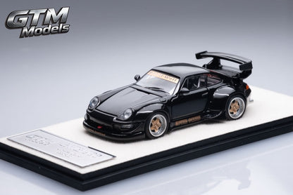 Front three-quarter view of the black GTM RWB 993 widebody on its base