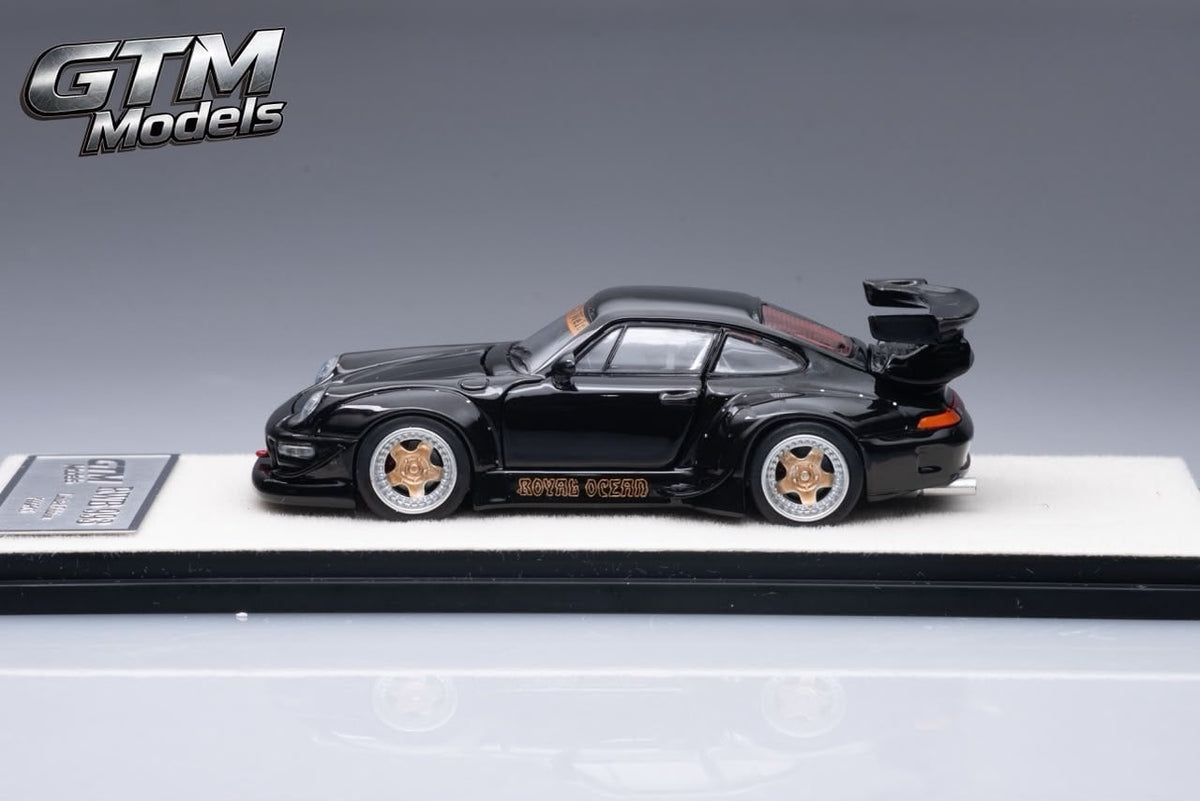 GTM Models RWB 993 in black with bronze wheels, side profile on its display base, 1:64