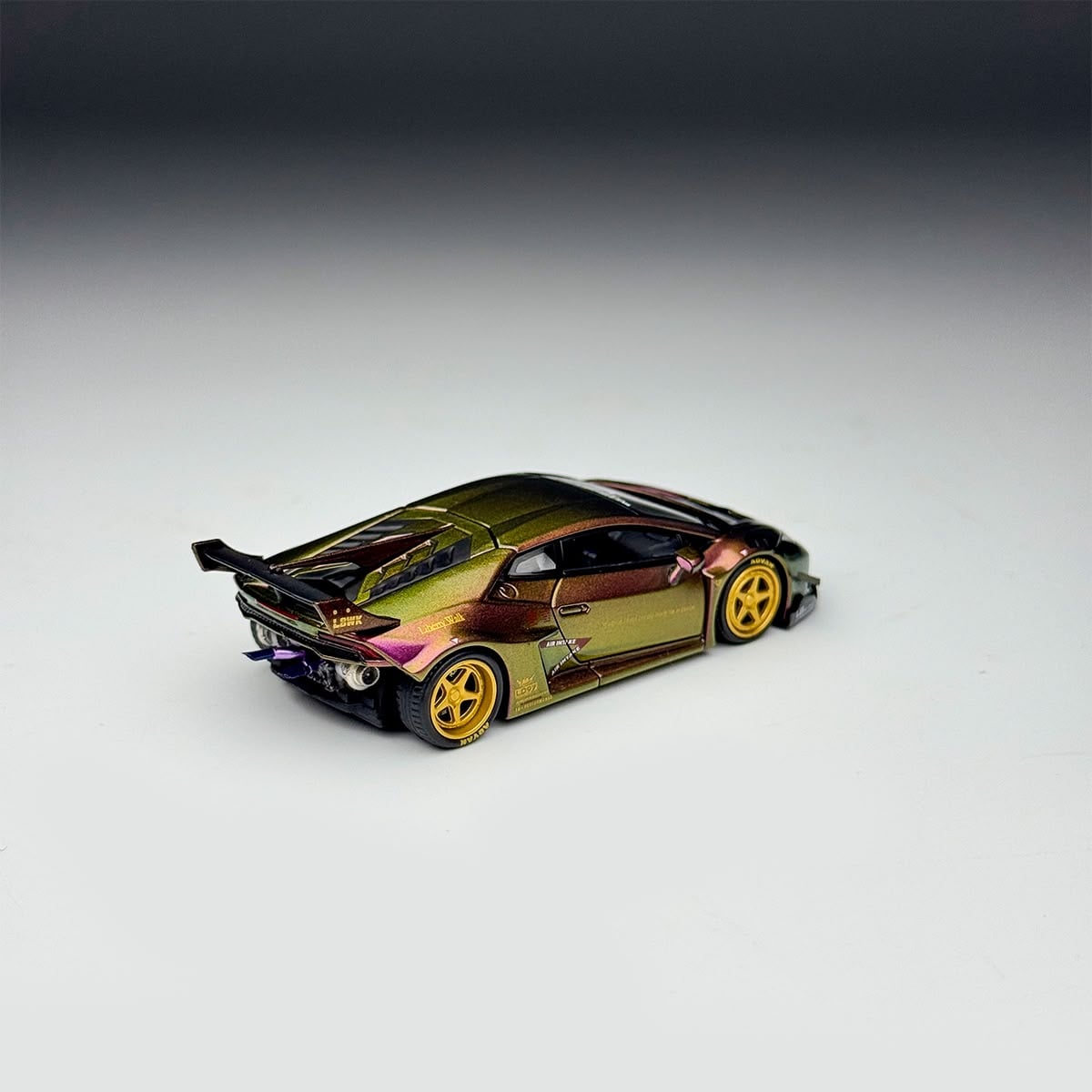 Rear three-quarter view of the chameleon Huracan GT, no rear bumper, exposed exhaust and wing