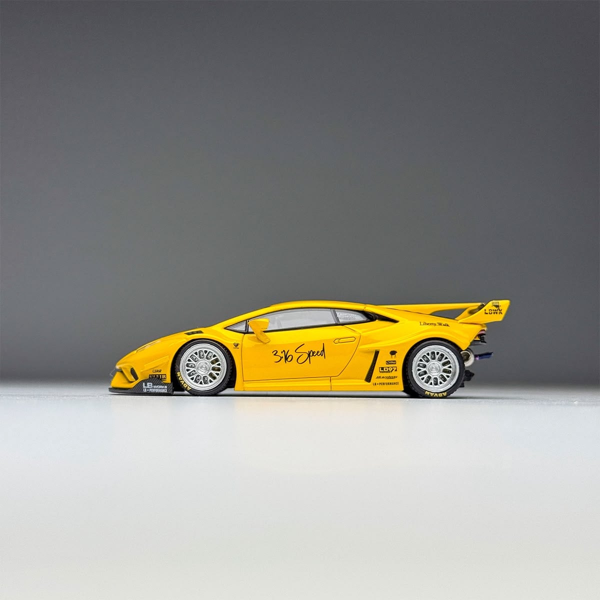 Side profile of the yellow LBWK Huracan GT with its tall rear wing