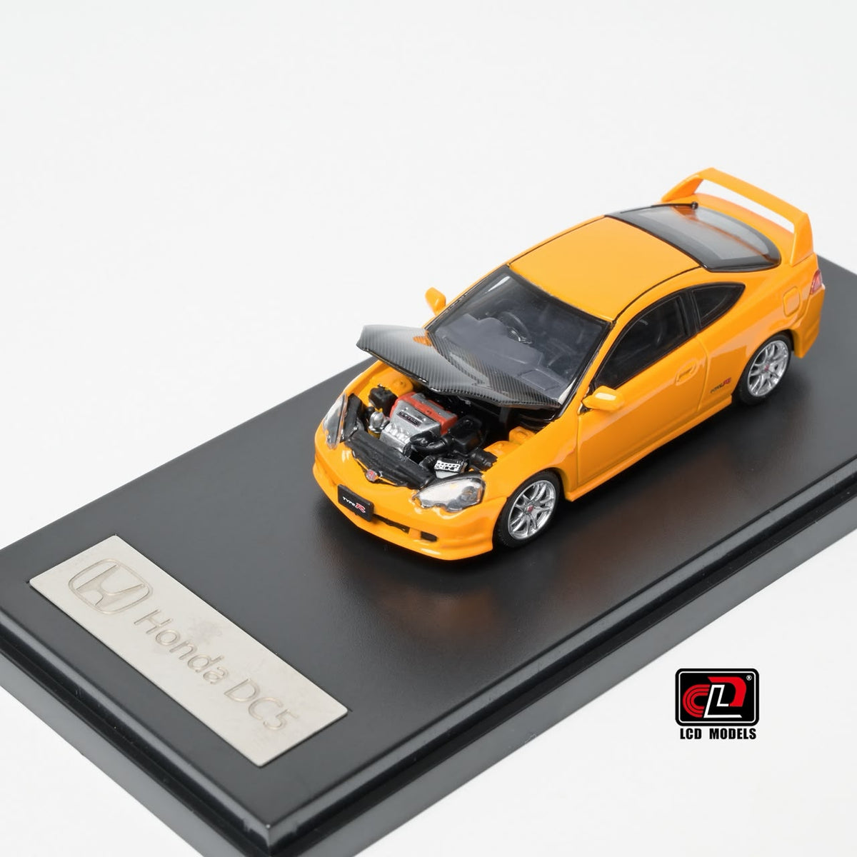 LCD Honda Integra DC5 Type-R 1:64 in yellow, front three-quarter with the carbon bonnet raised over the detailed engine bay