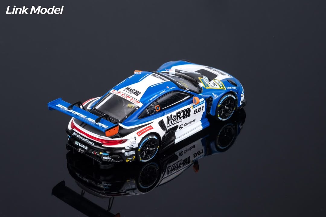 Rear three-quarter view of the white and blue H&R 911 GT3 R with Muhlner Motorsport rear wing