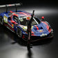 MechSpeed 296GT3 1:64, blue Red Bull #31 livery, front three-quarter close-up with the driver figure in a Red Bull helmet raising one arm