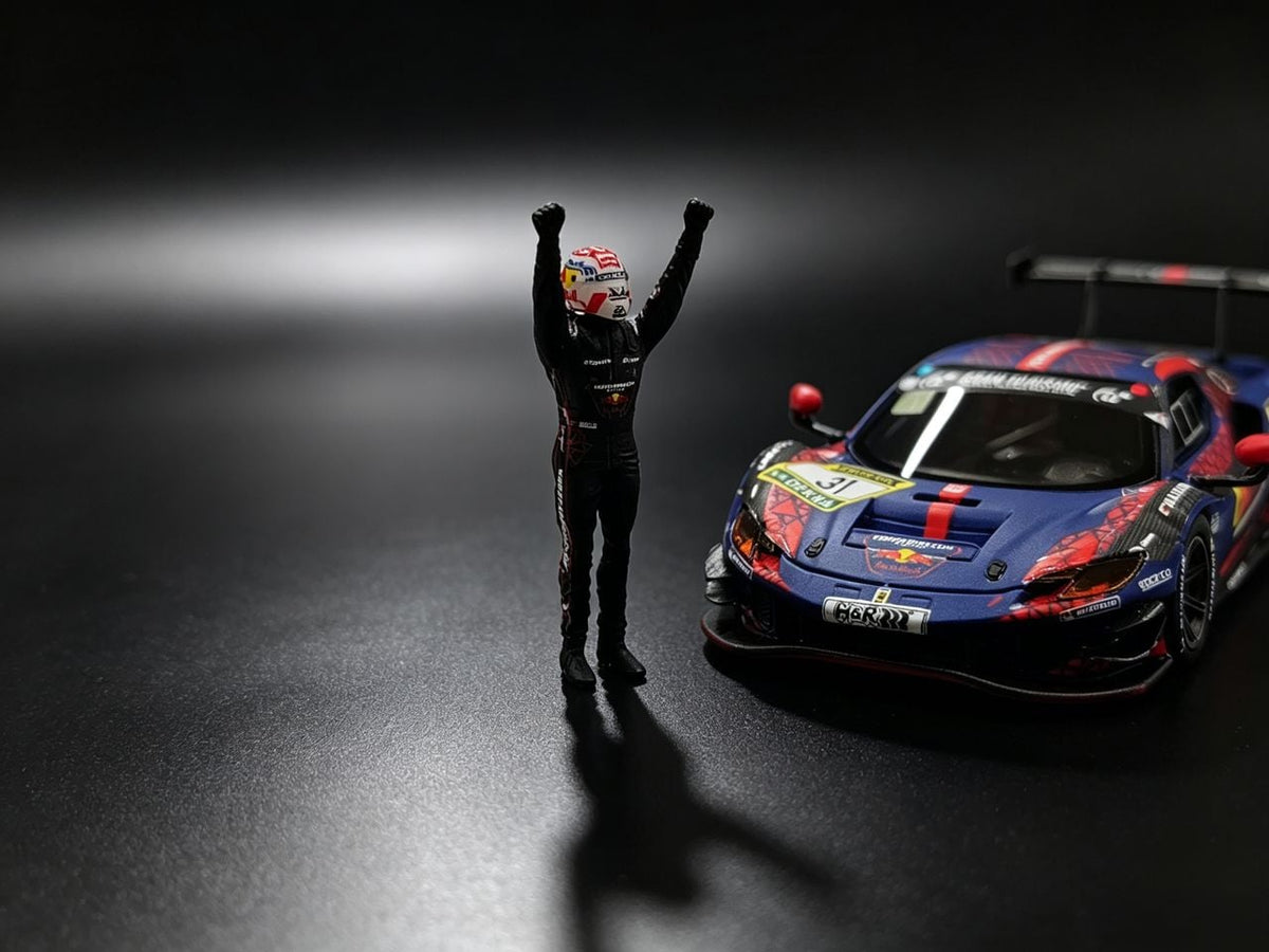 MechSpeed 296GT3 1:64 in blue Red Bull #31 livery seen head-on, with the celebrating driver figure in a Red Bull helmet in the foreground