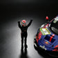 Close-up of the MechSpeed 296GT3 1:64 nose in blue Red Bull livery with the DEKRA 31 roundel, beside a driver figure with both arms raised