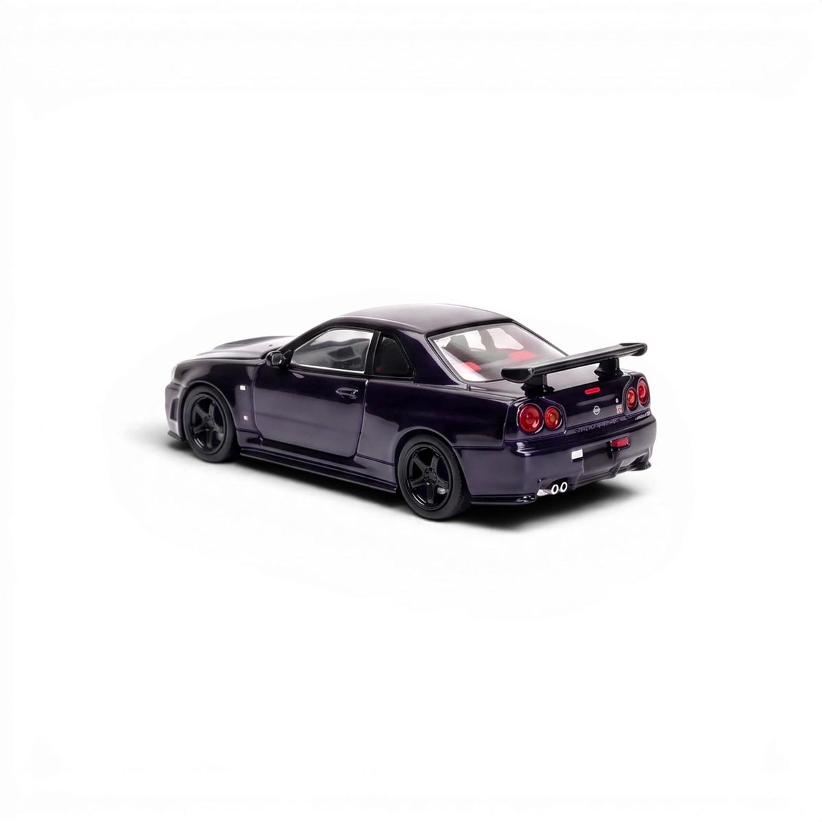 MOTORHELIX Nissan Skyline GT-R R34 midnight purple 1:64, rear three-quarter showing the GT wing, round quad tail lights and twin exhaust