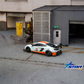 Star Models McLaren 650S Wide-Body - Gulf Livery (Ltd 699) 1:64 diecast model, rear three-quarter in garage diorama