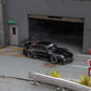 Star Models 1:64 Porsche 997 widebody in gloss black, front three-quarter from the right