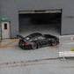 Star Models 1:64 Porsche 997 widebody in gloss black, rear three-quarter showing the large rear wing