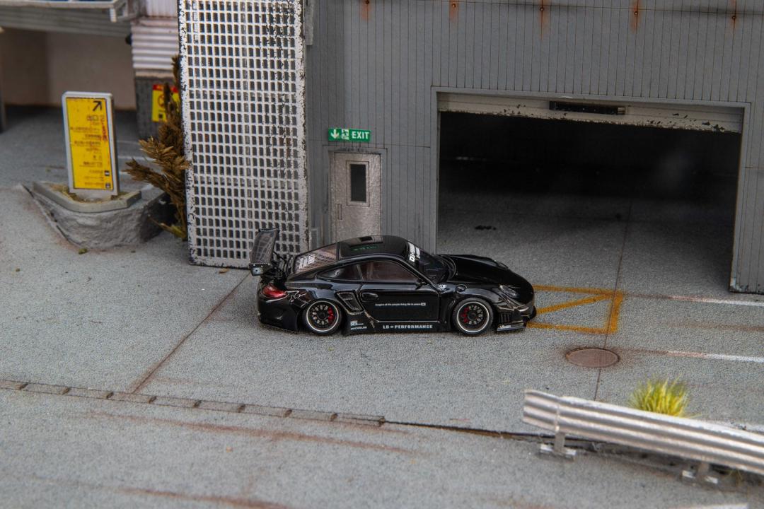 Star Models 1:64 Porsche 997 widebody in gloss black, full side profile showing the widebody fenders