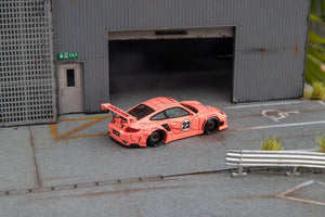Star Models 1:64 Porsche 997 widebody in Pink Pig livery with number 23 roundel, rear three-quarter showing the large rear wing and butcher-cut graphics
