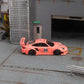 Star Models 1:64 Porsche 997 widebody in Pink Pig livery with number 23 roundel, full side profile showing the widebody fenders