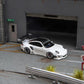 Star Models 1:64 Porsche 997 widebody in white with a carbon roof, front three-quarter from the right showing the wide arches