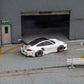 Star Models 1:64 Porsche 997 widebody in white with a carbon roof, rear three-quarter showing the large rear wing