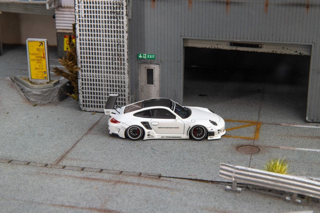 Star Models 1:64 Porsche 997 widebody in white with a carbon roof, full side profile showing the widebody fenders