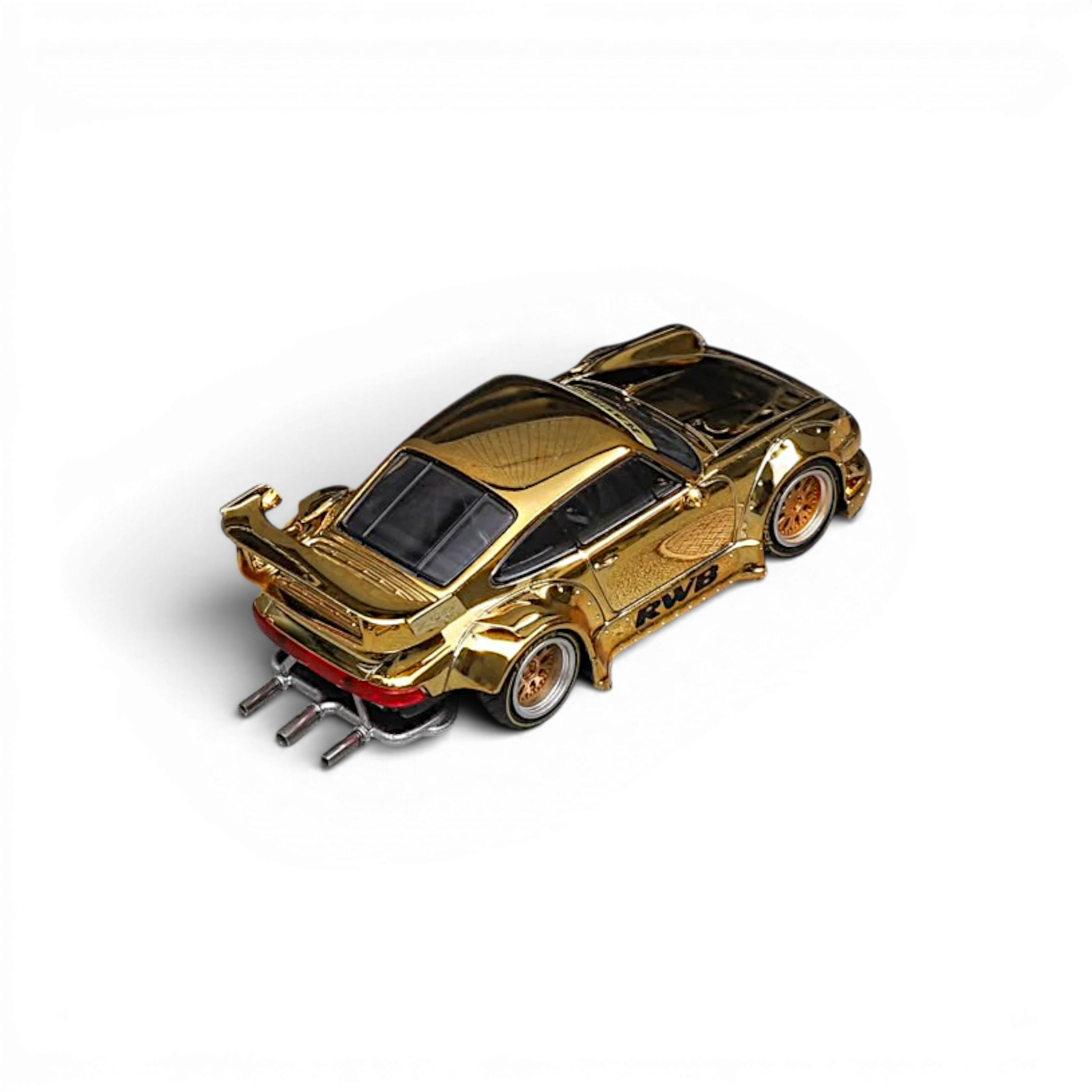 Star Models RWB 930 GT Wing chrome gold 1:64, elevated rear three-quarter showing the GT wing and chrome side-exit exhaust pipes