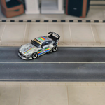 SW RWB Porsche 993 Apple Racing Livery Low Wing 1:64 diecast model, front three-quarter on a diorama road