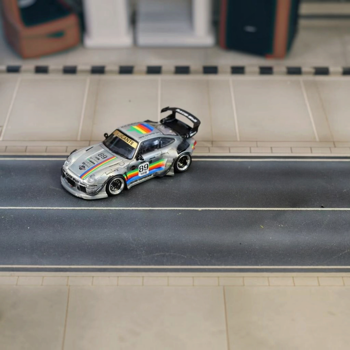 SW RWB Porsche 993 Apple Racing Livery Low Wing 1:64 diecast model, front three-quarter on a diorama road
