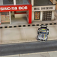 SW RWB Porsche 993 Apple Racing Livery Low Wing 1:64 diecast model, front view in a street diorama with rainbow stripe