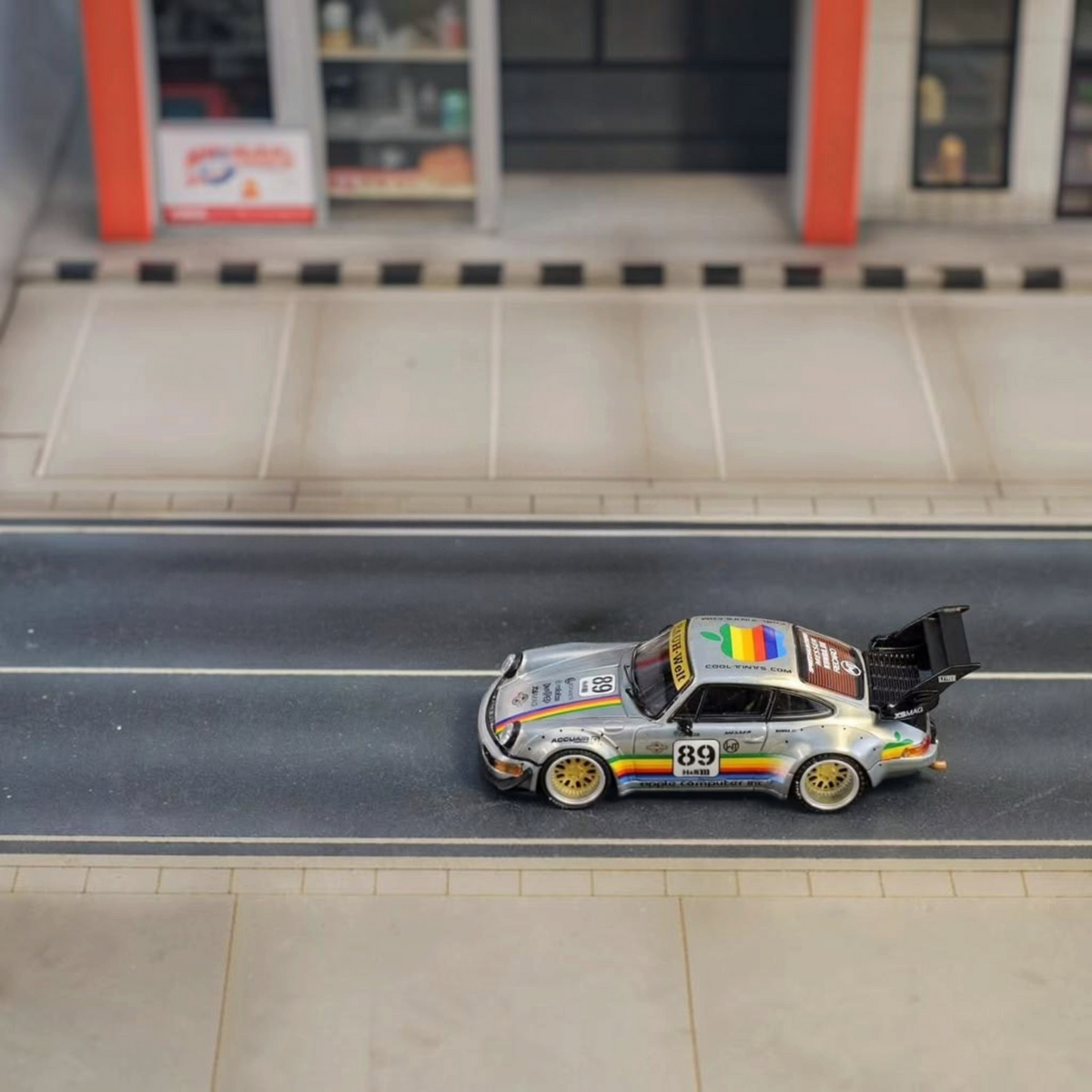 SW RWB Porsche 993 Apple Racing Livery Low Wing 1:64 diecast model, side profile on a street diorama