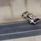 SW RWB Porsche 993 Apple Racing Livery Low Wing 1:64 diecast, high-angle rear three-quarter on a road diorama