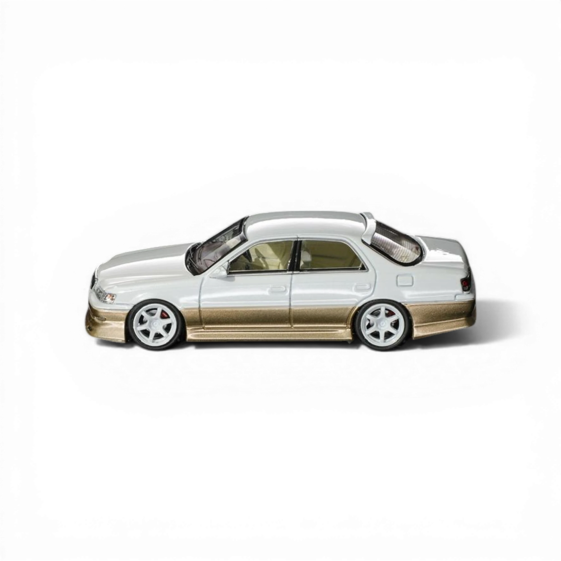 Lot57Supplies Diecast Shop 1:64 scale pearl white and gold diecast Cresta model car with metallic paint.