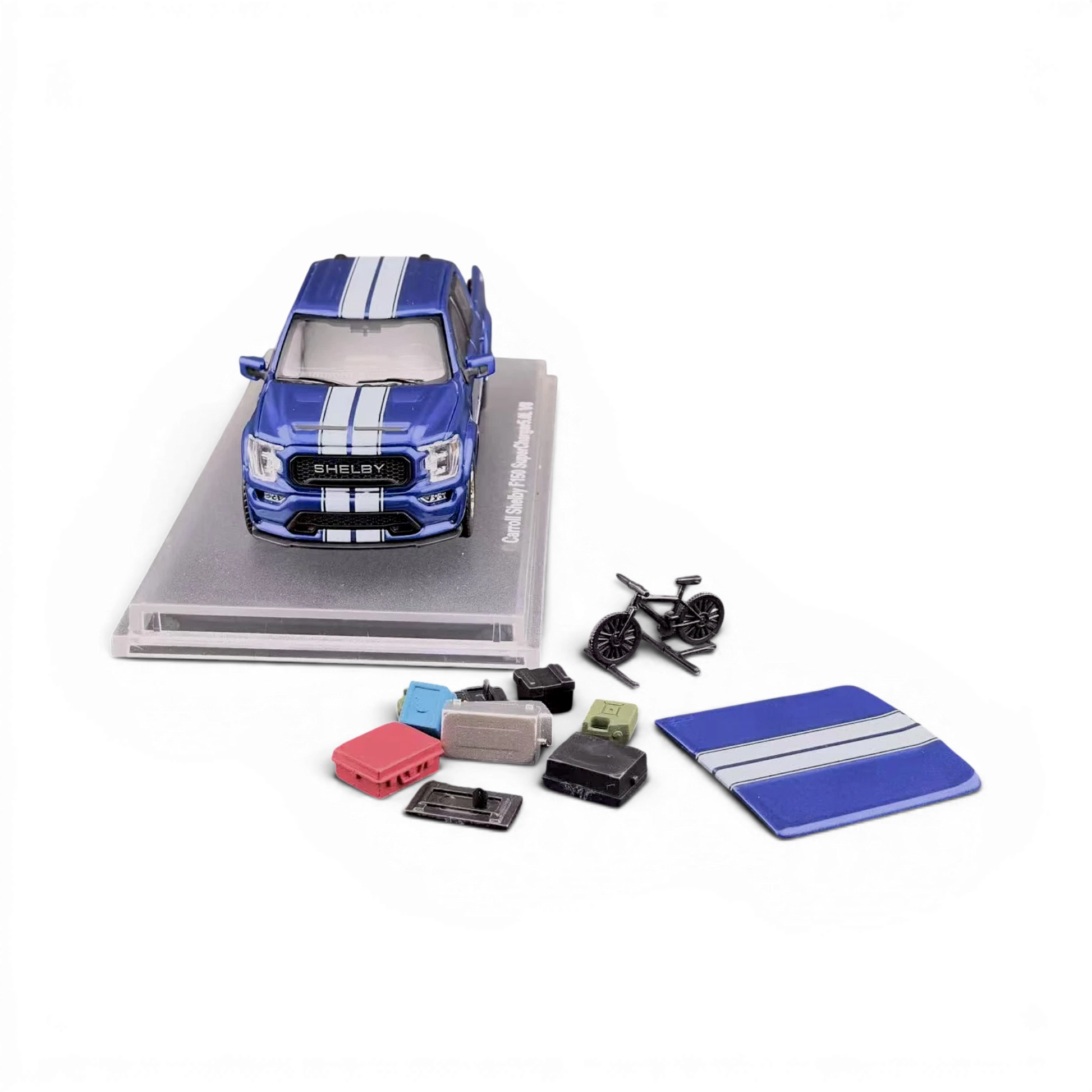 Lot57Supplies Diecast Shop 1:64 blue Ford Shelby F-150 pickup truck with white racing stripes, displayed with accessories.