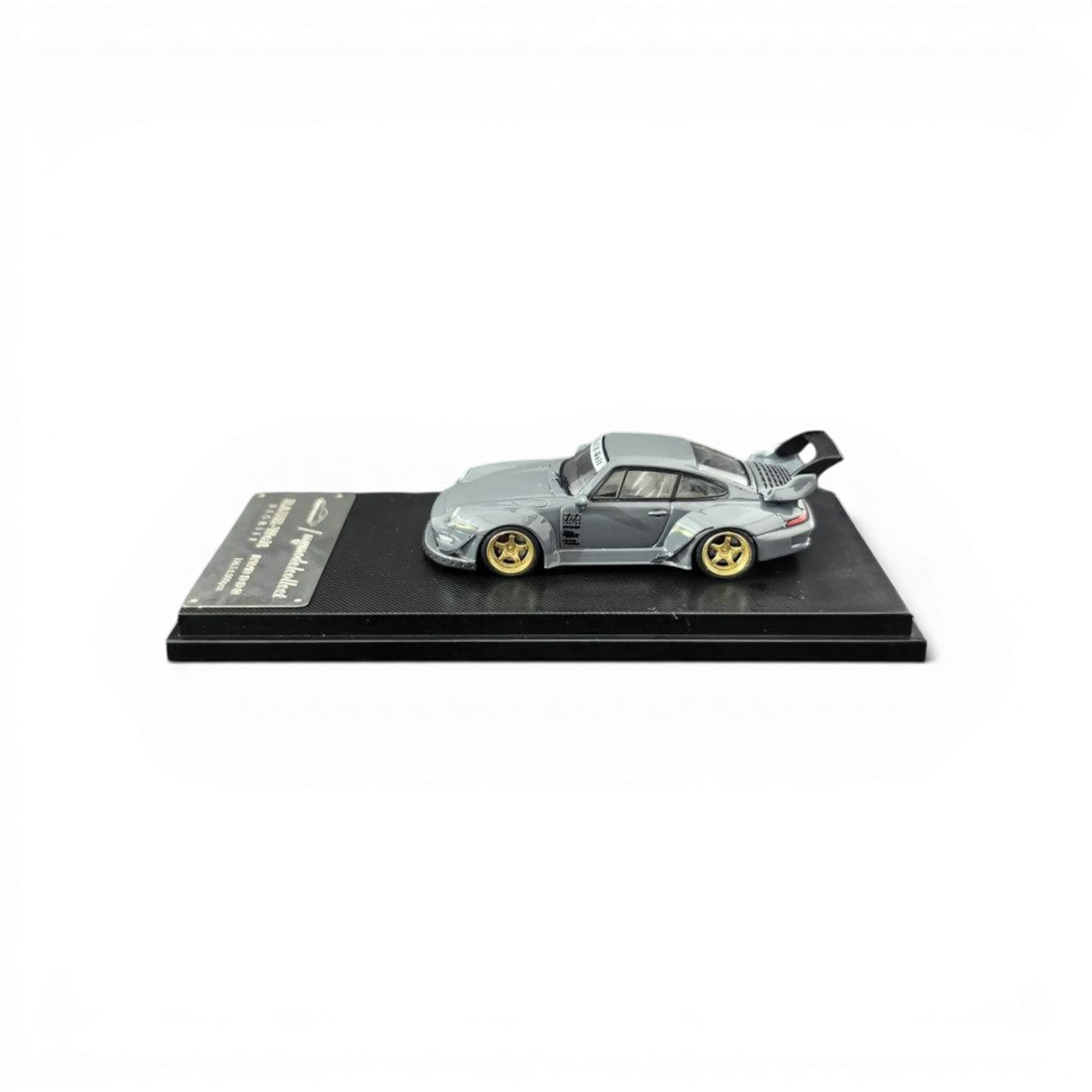 Lot57Supplies Diecast Shop MC RWB 993 G2 Single Deck Wing, 1:64 scale, cement grey diecast car with gold wheels and a large rear spoiler.