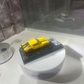 Lot57Supplies Diecast Shop yellow 1978 Camaro Bumblebee diecast model car on a textured display base